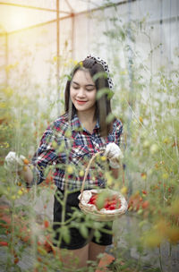 Beautiful young woman holding red fruit
