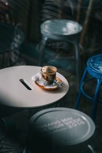 High angle view of empty chairs and table in cafe