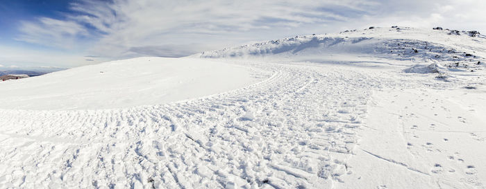 Scenic view of snow covered mountains against sky