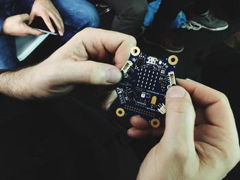 Midsection of man using mobile phone