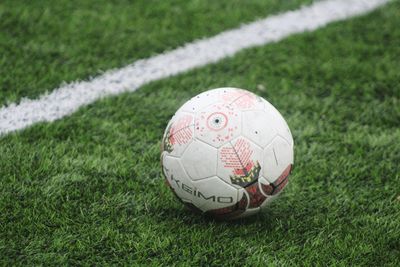 Close-up of soccer ball on field