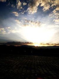 Scenic view of silhouette field against sky during sunset