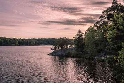 Scenic view of river against cloudy sky