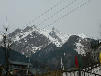 Snow covered mountains against clear sky