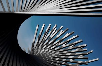 Low angle view of metallic structure against blue sky