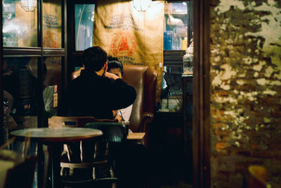 Rear view of woman sitting in restaurant