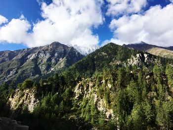 Scenic view of mountains against cloudy sky