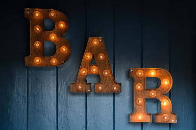 Close-up of illuminated text on wall