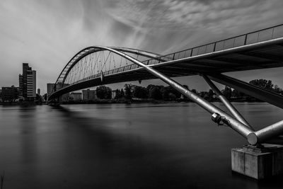 View of bridge over river against cloudy sky