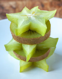 Close-up of starfruits and kiwis in plate