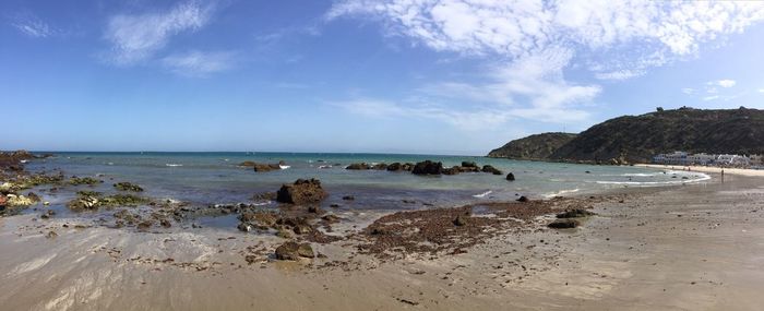 Scenic view of beach against blue sky