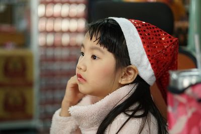 Close-up of cute girl looking away