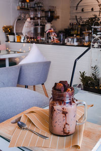 Close-up of milkshake in jar on table in restaurant