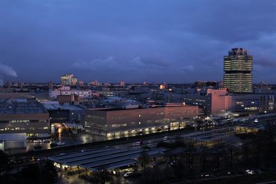 High angle view of illuminated buildings in city at night, the bmw fabric in munich