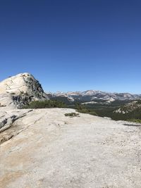 Scenic view of mountains against clear blue sky