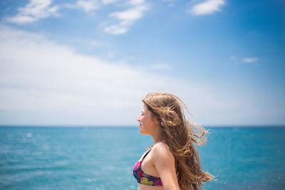 Woman wearing hat against sea against sky