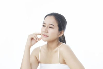 Portrait of a beautiful young woman over white background