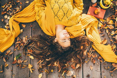 Directly above shot of woman lying on wooden floor