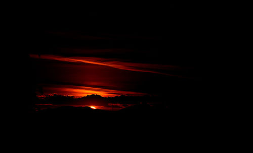 Scenic view of silhouette mountain against sky at night