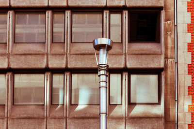 Close-up of street light against building