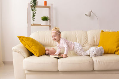 Portrait of woman sitting on sofa at home