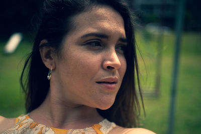 Close-up portrait of young woman looking away