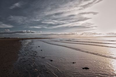 Scenic view of beach against sky during sunset