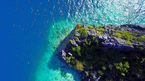 High angle view of rocks on sea shore