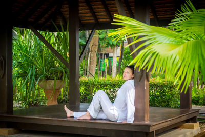 Side view of a woman sitting outdoors