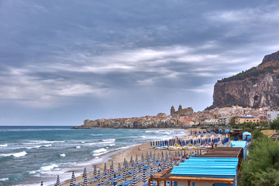 View of beach against cloudy sky