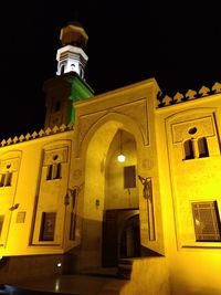 Low angle view of illuminated cathedral against sky at night