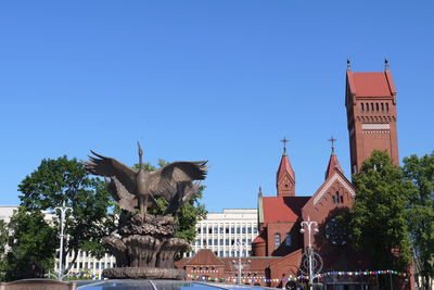 Low angle view of building against clear blue sky