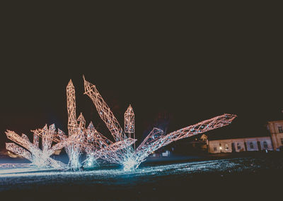 Firework display against clear sky at night