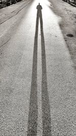 Shadow of person standing on road