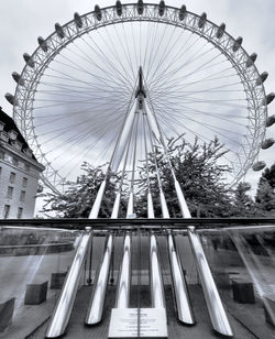 Low angle view of ferris wheel in city