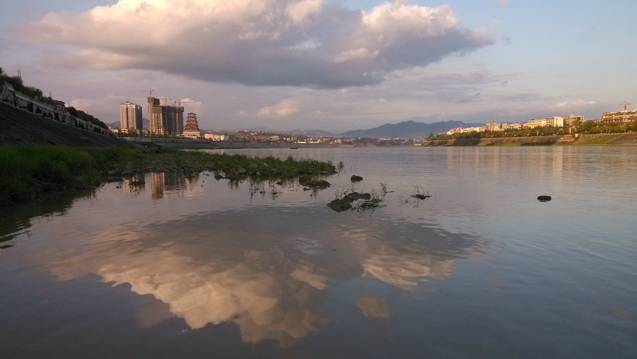 architecture, water, building exterior, built structure, sky, cloud - sky, waterfront, reflection, cloudy, river, cloud, city, lake, rippled, nature, outdoors, scenics, tranquility, dusk, mid distance