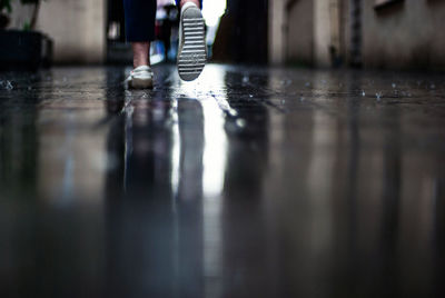 Rear view low section of man walking on floor