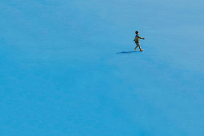 Man in snow against clear sky