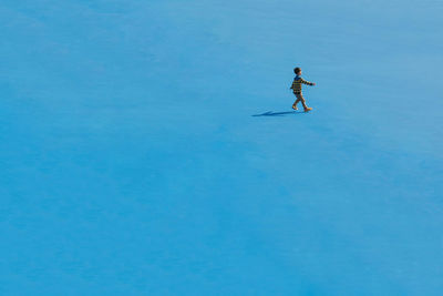 Man in snow against clear sky