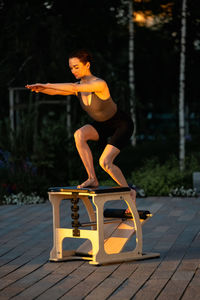 Side view of woman exercising in park