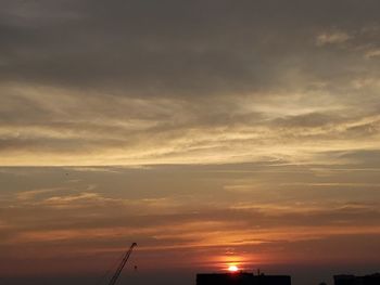 Low angle view of silhouette buildings against sky during sunset