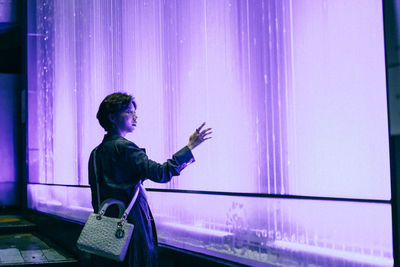 Side view of man using mobile phone