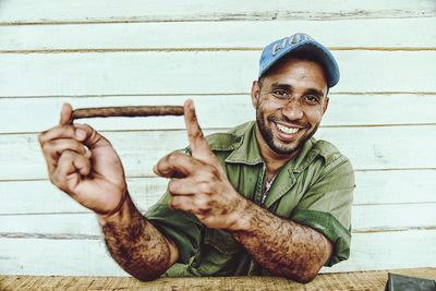 Portrait of a smiling young man sitting outdoors