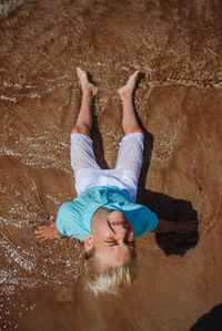 High angle view of young woman standing in water