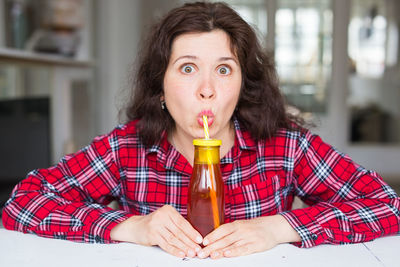 Portrait of woman in drinking from bottle