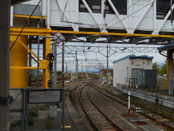 Train at railroad station against sky