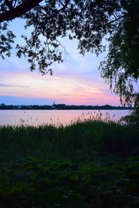 Scenic view of lake against sky during sunset