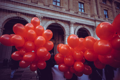 Low angle view of red balloons on building