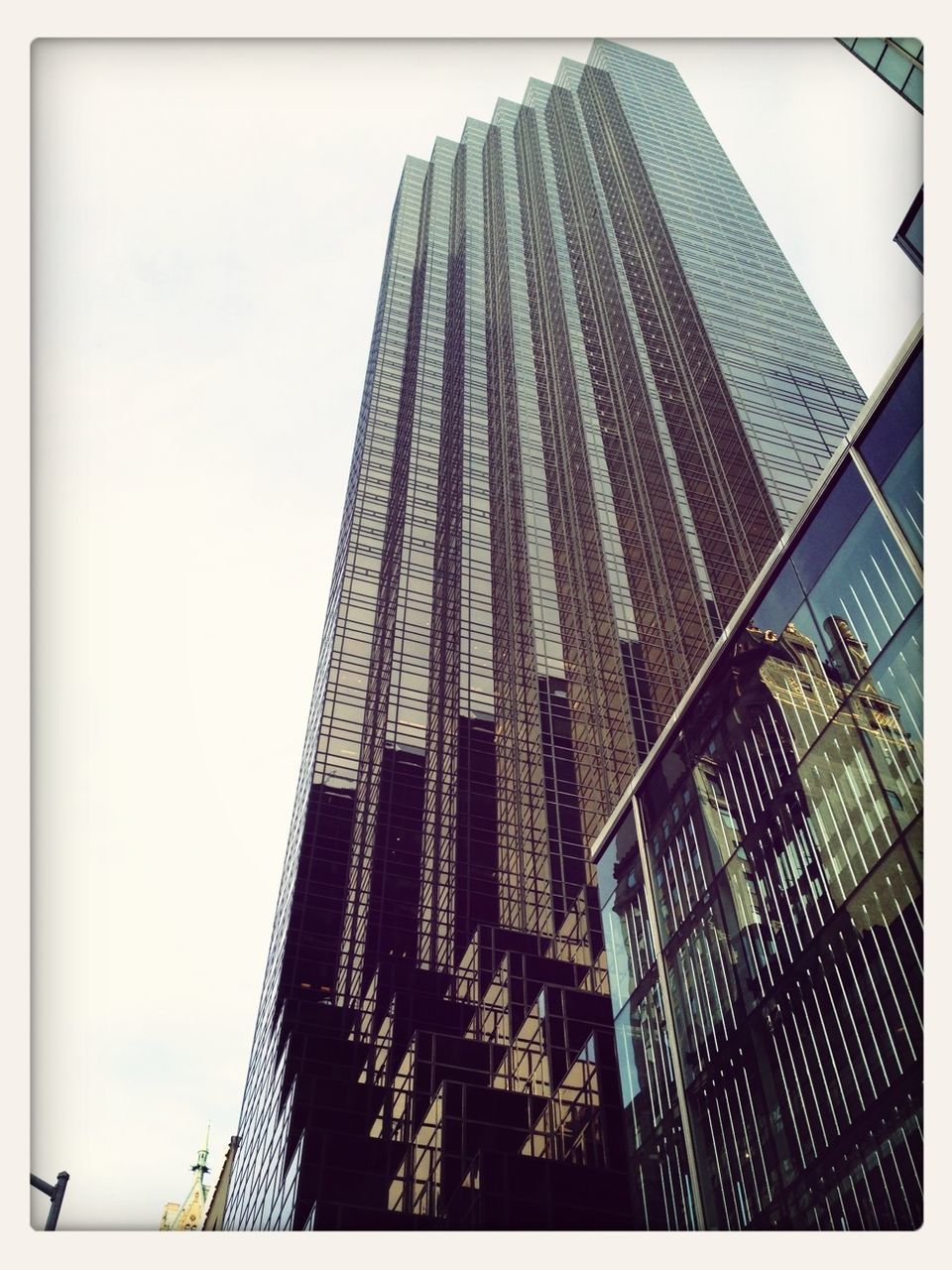 architecture, built structure, building exterior, skyscraper, low angle view, tall - high, modern, tower, office building, city, transfer print, capital cities, tall, auto post production filter, sky, famous place, clear sky, travel destinations, building, glass - material