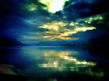 Scenic view of lake against cloudy sky